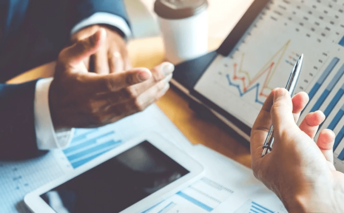 hotel developers analysing financial projections on a tablet