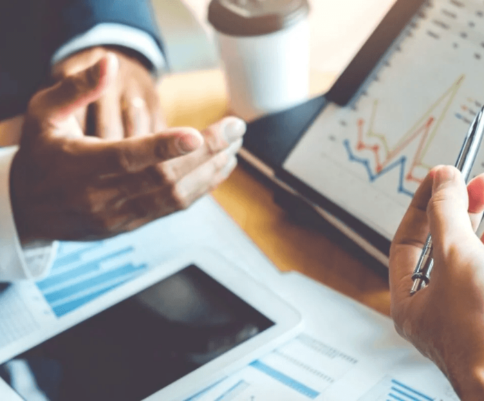 hotel developers analysing financial projections on a tablet