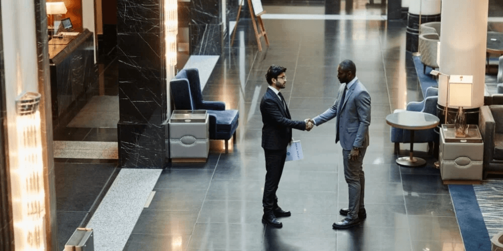 Hotel staff and asset manager meeting in a hotel lobby